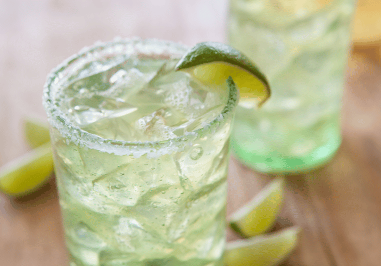 Margarita mocktail in a salt-rimmed glass with ice and lime wedge | Angelia Mendoza
