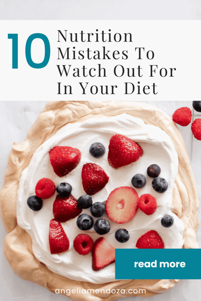 Top-down view of a meringue dessert topped with whipped cream, strawberries, blueberries, and raspberries, representing nutritional mistakes related to sugar and perceived healthiness.
