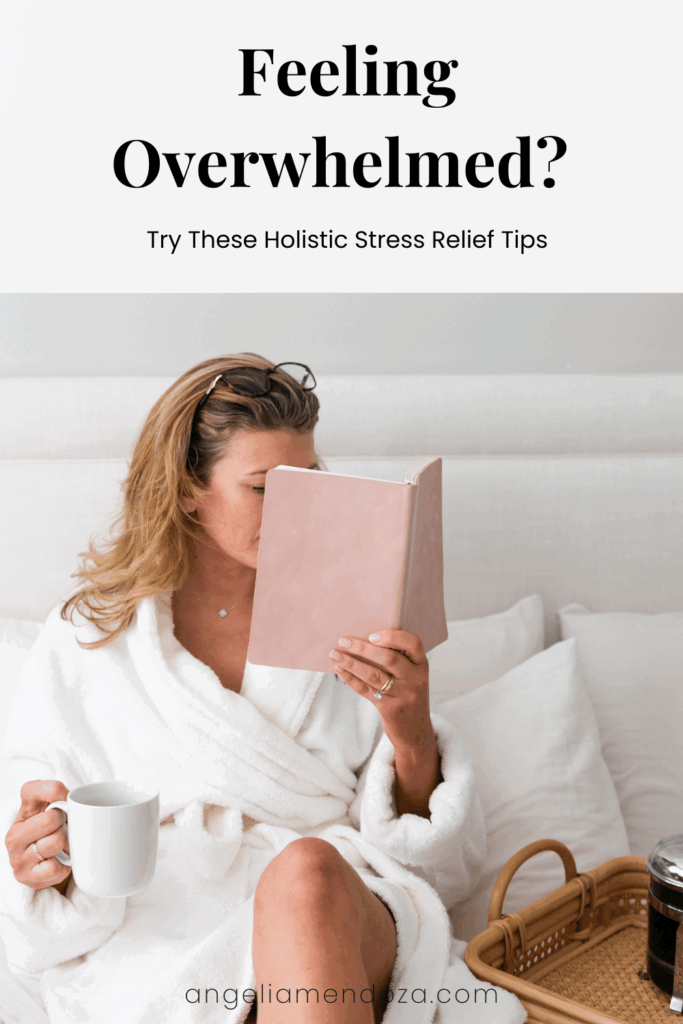A woman in a white robe sits on a bed reading a pink journal and holding a white mug. She appears calm and relaxed, illustrating holistic stress management and self-care.