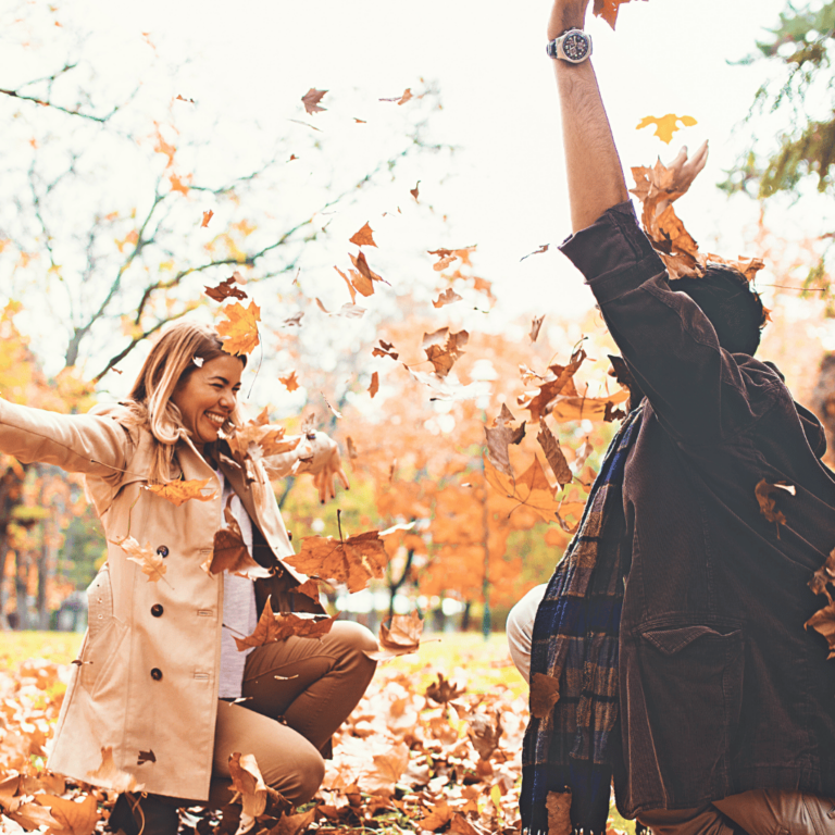 50 Unique Fall Bucket List Ideas | Couple playing in leaves