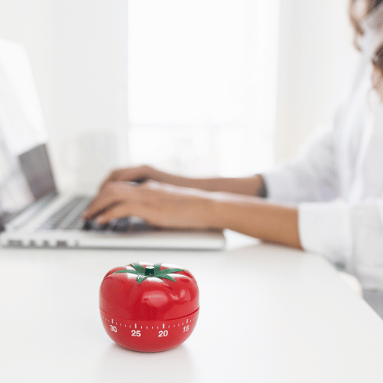 The Pomodoro Technique: How To Make it Work For You | Woman working on computer and timer