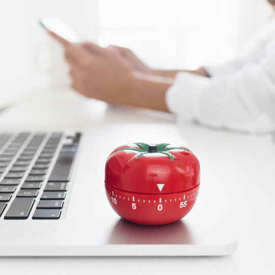 The Pomodoro Technique: How To Make it Work For You | Kitchen timer on top of a computer