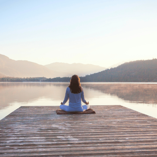 7-Day Holistic Stress Management Plan for Women Over 40 | Woman seated by lake