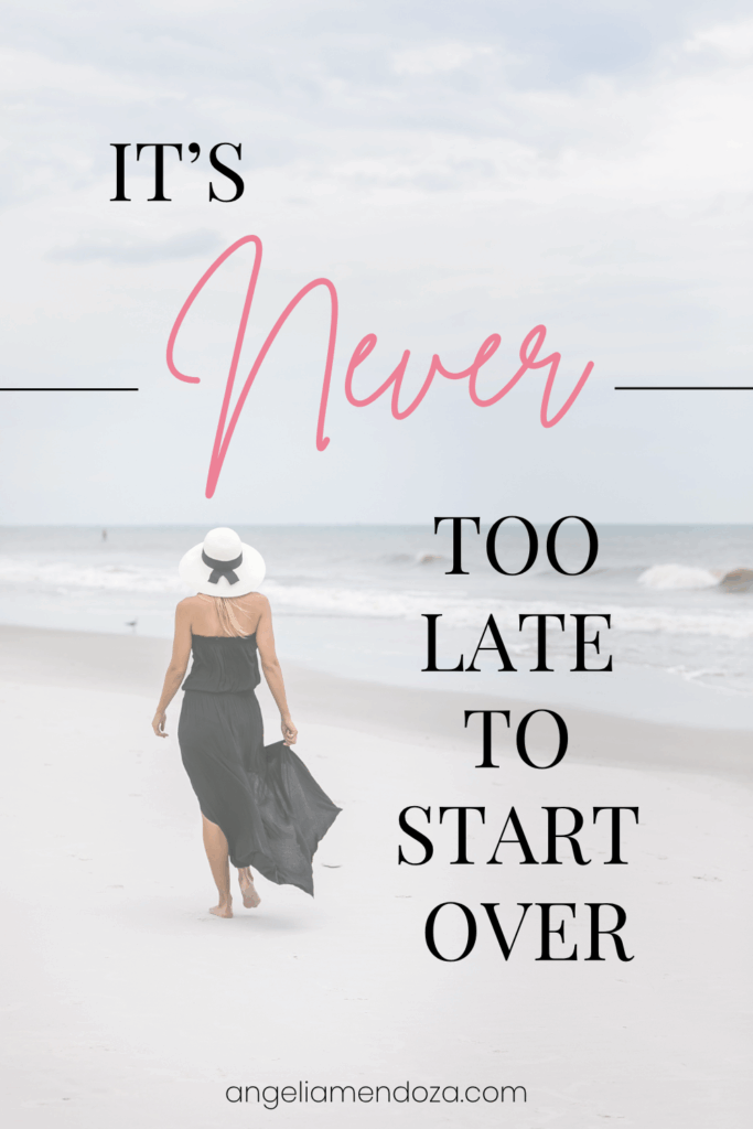 Woman walking barefoot along a peaceful beach in a flowing black dress and white sunhat, with text overlay that reads “It’s Never Too Late to Start Over,” symbolizing hope, healing, and fresh beginnings.