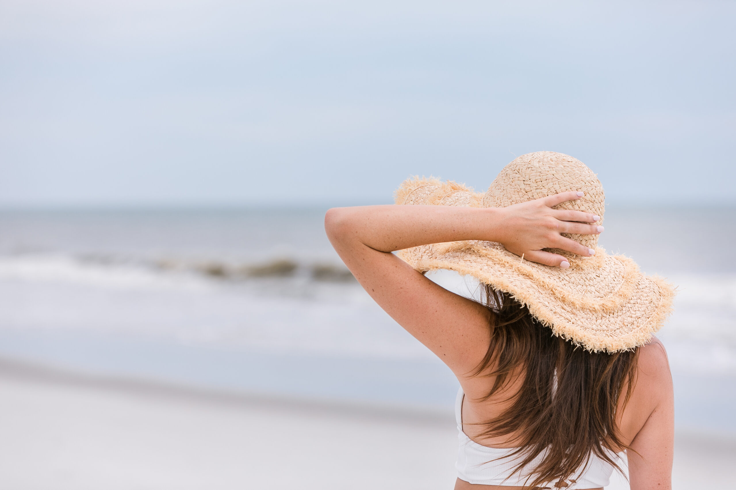 Healing with Angelia - Woman looking down the beach